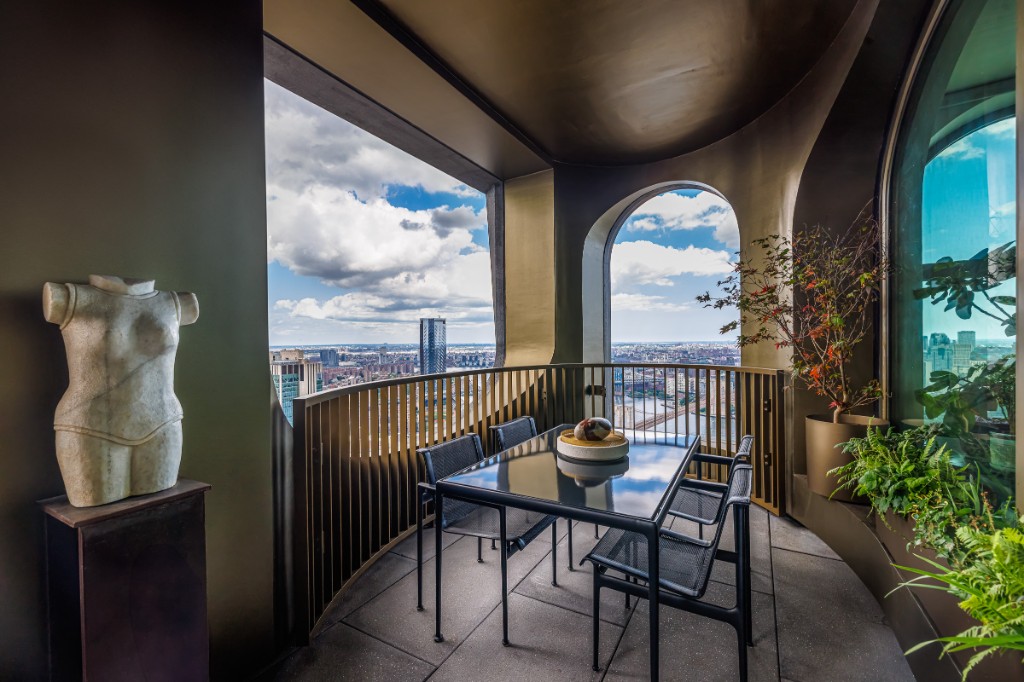 Loggia with dining table and city view